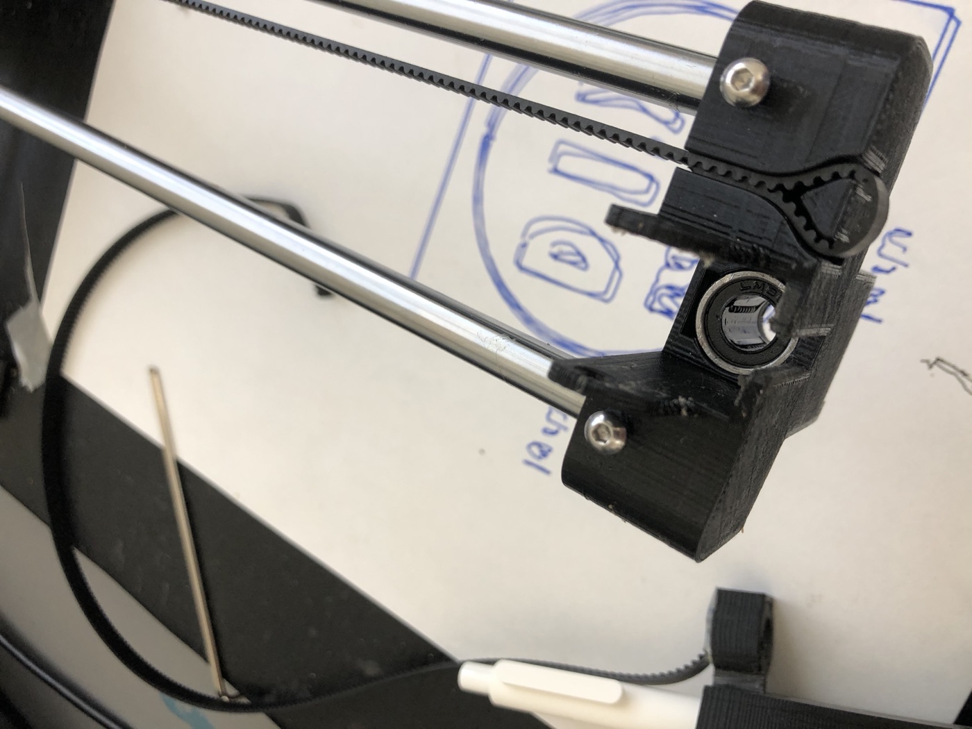 Gantry corner: smooth rod, linear bearing, belt teeth gripped by a printed clamp