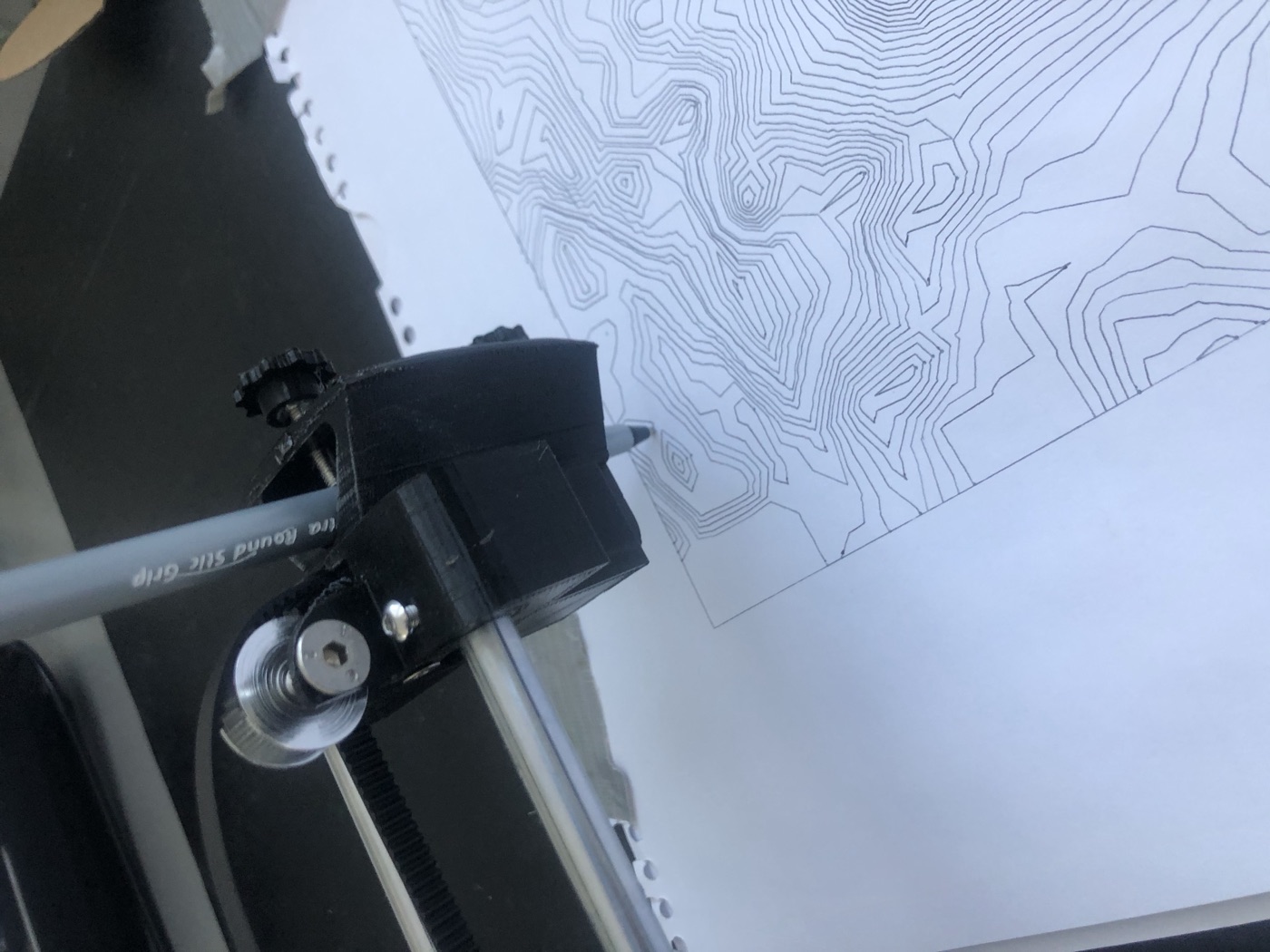 The pen tracing contour lines